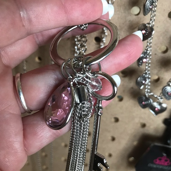 Long silver necklace w/assorted charms.
